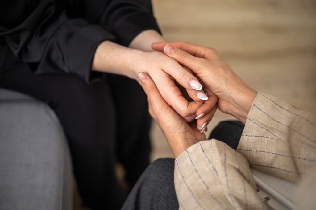 Hands clasped in comforting support
